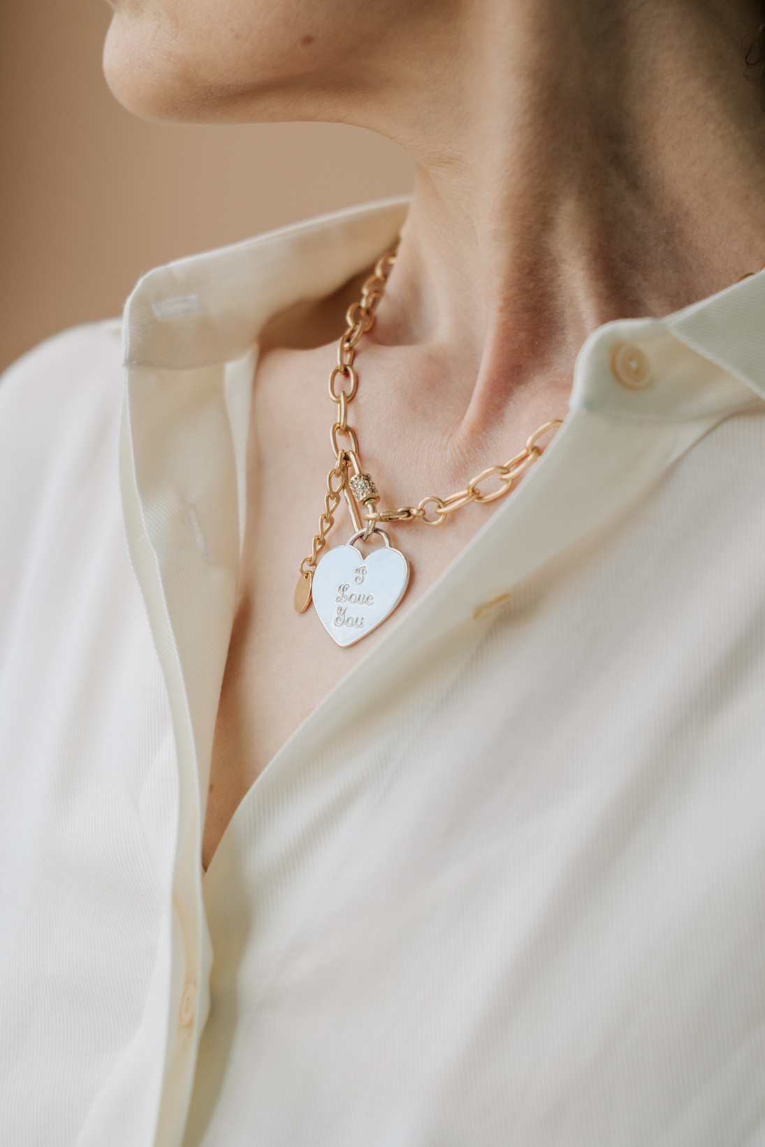Mature Woman Wearing a Gold Necklace with Heart Pendant